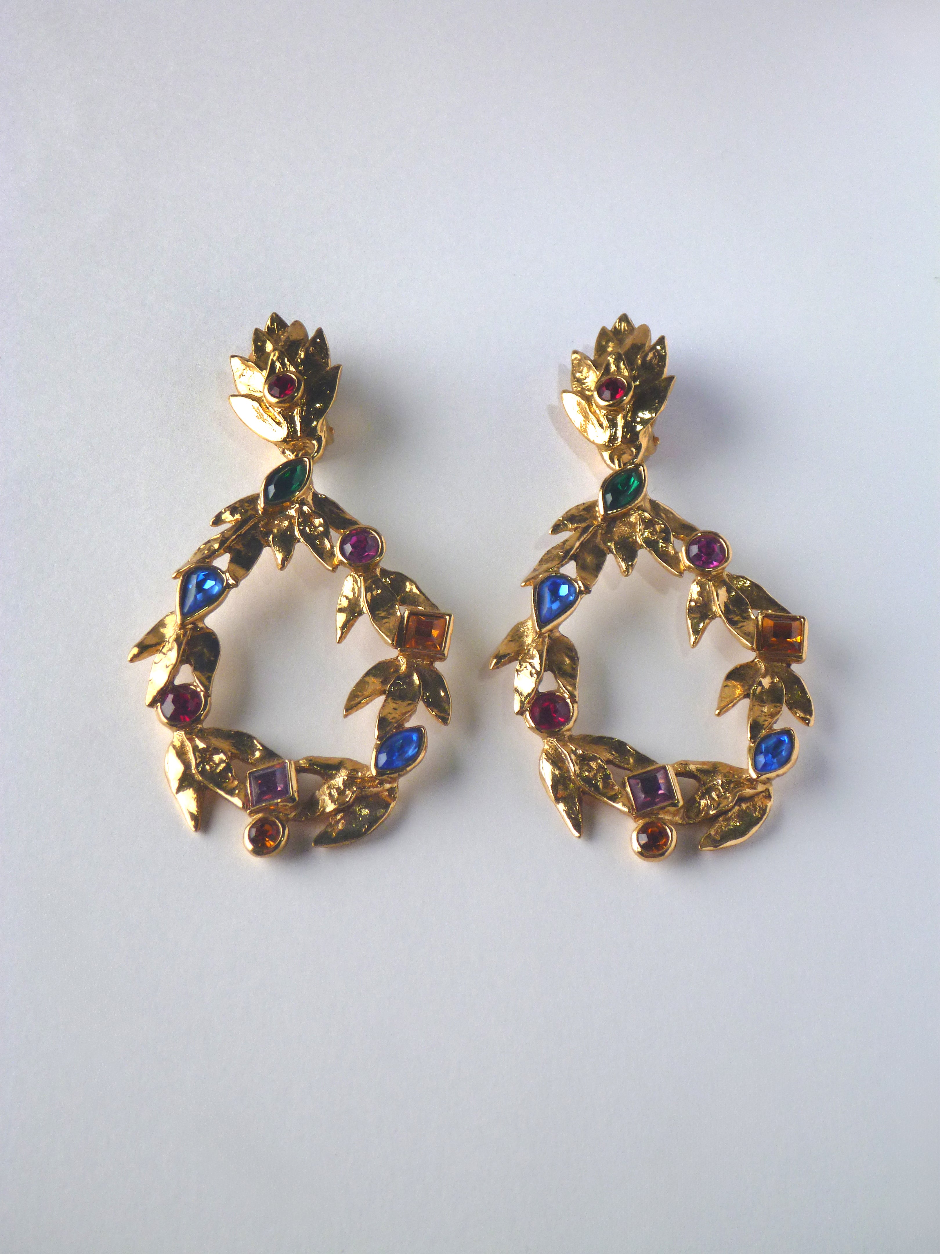 Vintage Yves Saint Laurent statement earrings featuring textured gold-tone laurel detailing and multicoloured crystal embellishments.